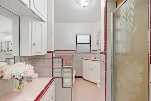 4840 Heleo Ave, Temple City, CA 91780 - full bath with tile walls, vanity, a stall shower, wainscoting, and tile patterned flooring