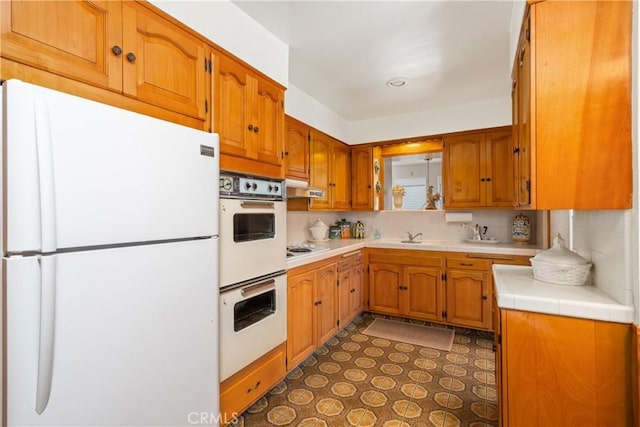4840 Heleo Ave, Temple City, CA 91780 - kitchen featuring white appliances, decorative backsplash, under cabinet range hood, and brown cabinets