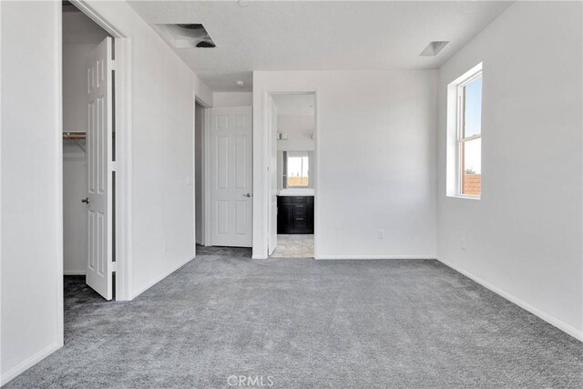 16124 Pablo Ct, Victorville, CA 92395 - unfurnished bedroom with carpet, a walk in closet, and ensuite bathroom