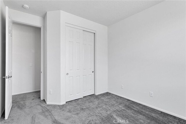 16124 Pablo Ct, Victorville, CA 92395 - unfurnished bedroom with carpet flooring, a closet, and a textured ceiling