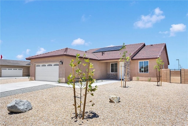 16124 Pablo Ct, Victorville, CA 92395 - view of front of home with stucco siding, solar panels, a garage, a tile roof, and concrete driveway
