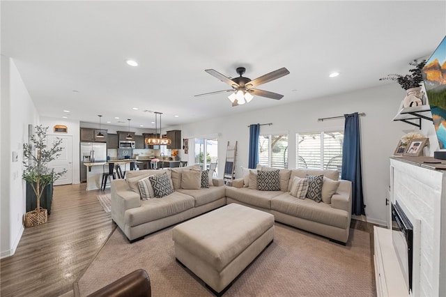 24212 Bay Laurel Ave, Murrieta, CA 92562 - living area featuring wood finished floors, recessed lighting, a fireplace, and ceiling fan