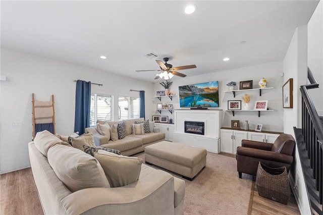 24212 Bay Laurel Ave, Murrieta, CA 92562 - living room with a ceiling fan, a glass covered fireplace, recessed lighting, stairs, and light wood finished floors