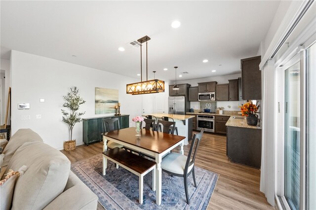 24212 Bay Laurel Ave, Murrieta, CA 92562 - dining space with a chandelier, light wood-style flooring, and recessed lighting