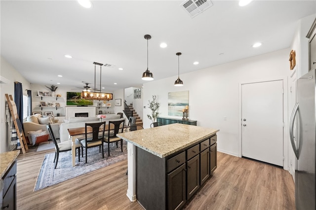 24212 Bay Laurel Ave, Murrieta, CA 92562 - kitchen featuring freestanding refrigerator, a fireplace, a ceiling fan, recessed lighting, and light wood finished floors