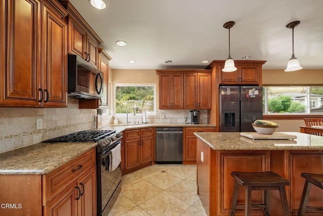872 Via Arroyo, Ventura, CA 93003 - kitchen with appliances with stainless steel finishes, brown cabinets, backsplash, hanging light fixtures, and recessed lighting