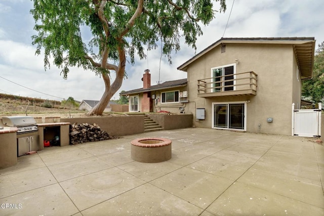 872 Via Arroyo, Ventura, CA 93003 - back of house featuring a balcony, stucco siding, a patio, a gate, and a chimney