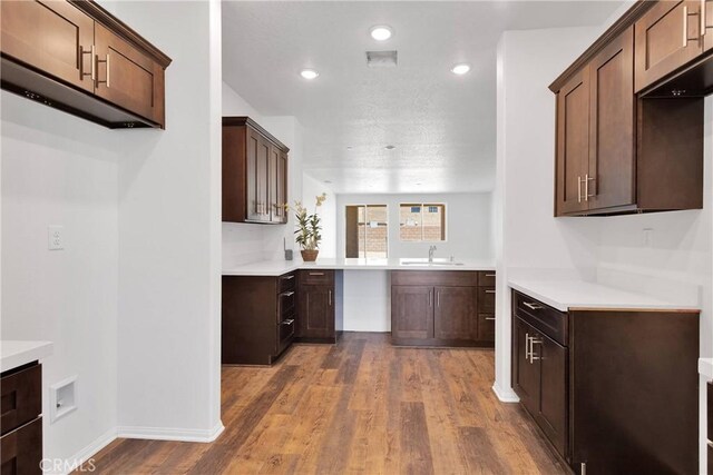 16148 Pablo Ct, Victorville, CA 92395 - kitchen featuring dark wood-type flooring, light countertops, recessed lighting, and dark brown cabinetry