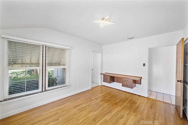 2460 Vuelta Grande Ave, Long Beach, CA 90815 - unfurnished room featuring wood finished floors and vaulted ceiling