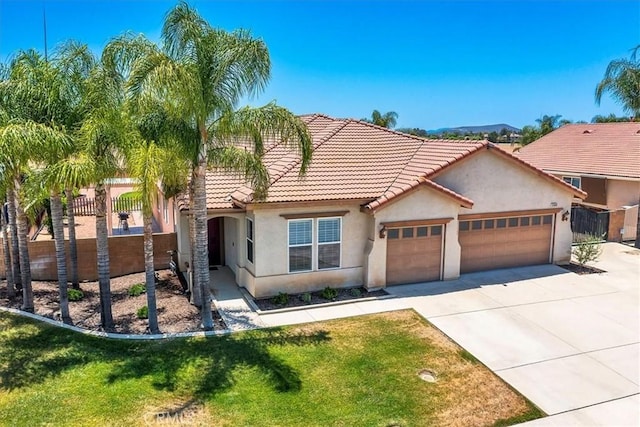 32669 Armoise Dr, Winchester, CA 92596 - mediterranean / spanish-style house featuring an attached garage, stucco siding, driveway, and a tiled roof