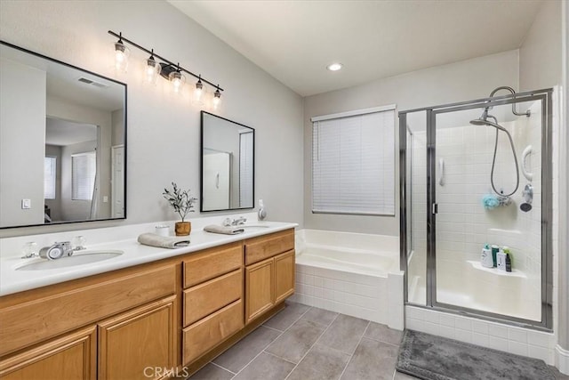 32669 Armoise Dr, Winchester, CA 92596 - bathroom featuring double vanity, a stall shower, a garden tub, tile patterned floors, and recessed lighting
