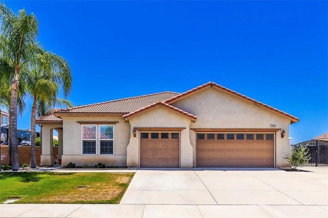 32669 Armoise Dr, Winchester, CA 92596 - mediterranean / spanish-style home with an attached garage, concrete driveway, stucco siding, and a tiled roof