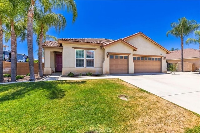 32669 Armoise Dr, Winchester, CA 92596 - mediterranean / spanish-style house with an attached garage, stucco siding, concrete driveway, and a tile roof