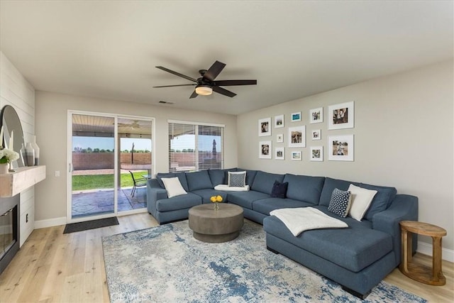 32669 Armoise Dr, Winchester, CA 92596 - living area with light wood finished floors, a ceiling fan, and a glass covered fireplace