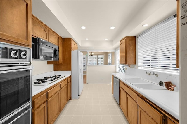 4159 Redline Dr, Lakewood, CA 90713 - kitchen with black appliances, light countertops, brown cabinets, and recessed lighting