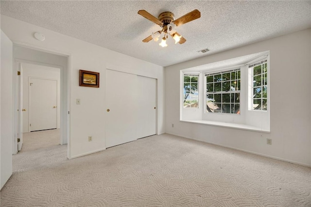 4159 Redline Dr, Lakewood, CA 90713 - unfurnished bedroom with carpet, a textured ceiling, a closet, and ceiling fan