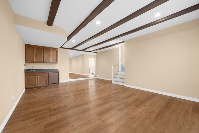4159 Redline Dr, Lakewood, CA 90713 - unfurnished living room featuring beam ceiling, recessed lighting, wet bar, stairs, and wood finished floors