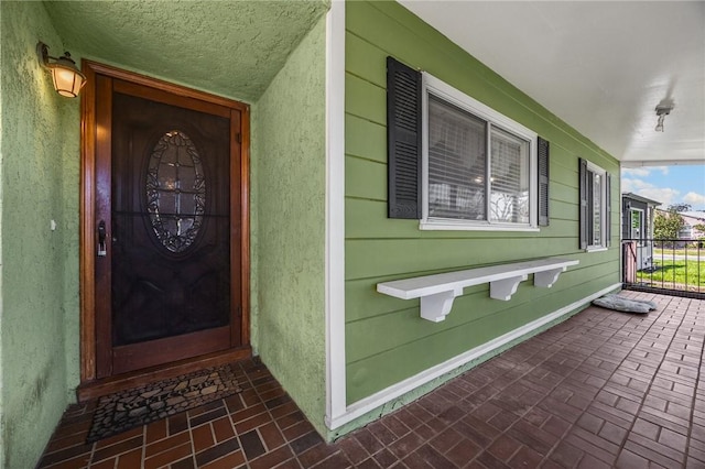 4159 Redline Dr, Lakewood, CA 90713 - doorway to property featuring covered porch and stucco siding