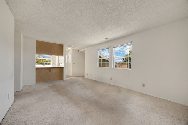 4159 Redline Dr, Lakewood, CA 90713 - unfurnished living room with light colored carpet and a textured ceiling