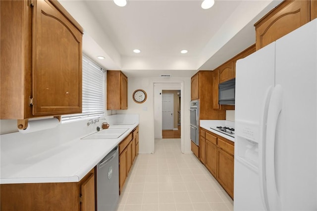 4159 Redline Dr, Lakewood, CA 90713 - kitchen with stainless steel appliances, brown cabinets, light countertops, and recessed lighting