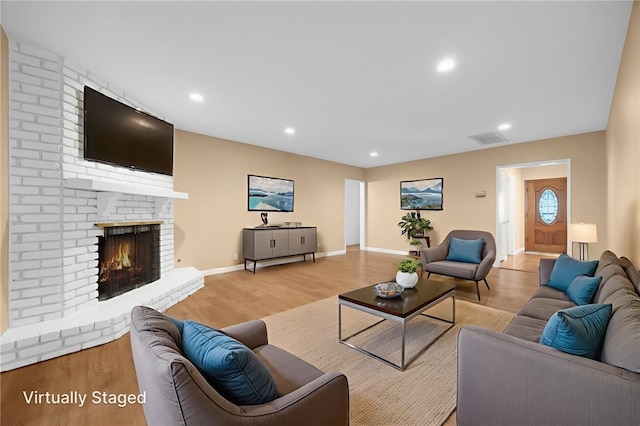 4159 Redline Dr, Lakewood, CA 90713 - living room featuring wood finished floors, a fireplace, and recessed lighting