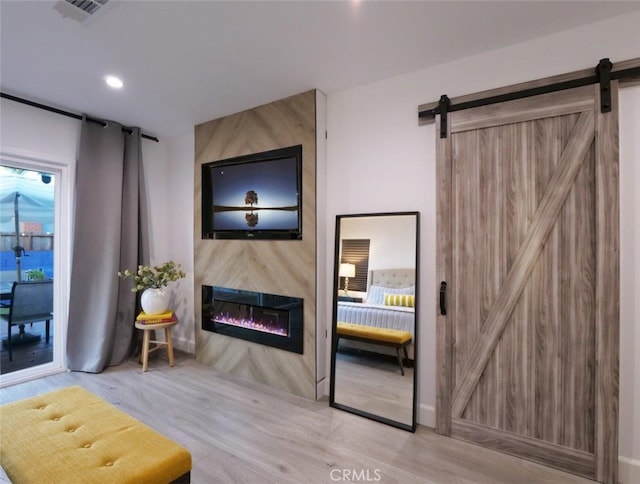5435 W 76th St, Los Angeles, CA 90045 - living room featuring a barn door, a fireplace, wood finished floors, and recessed lighting