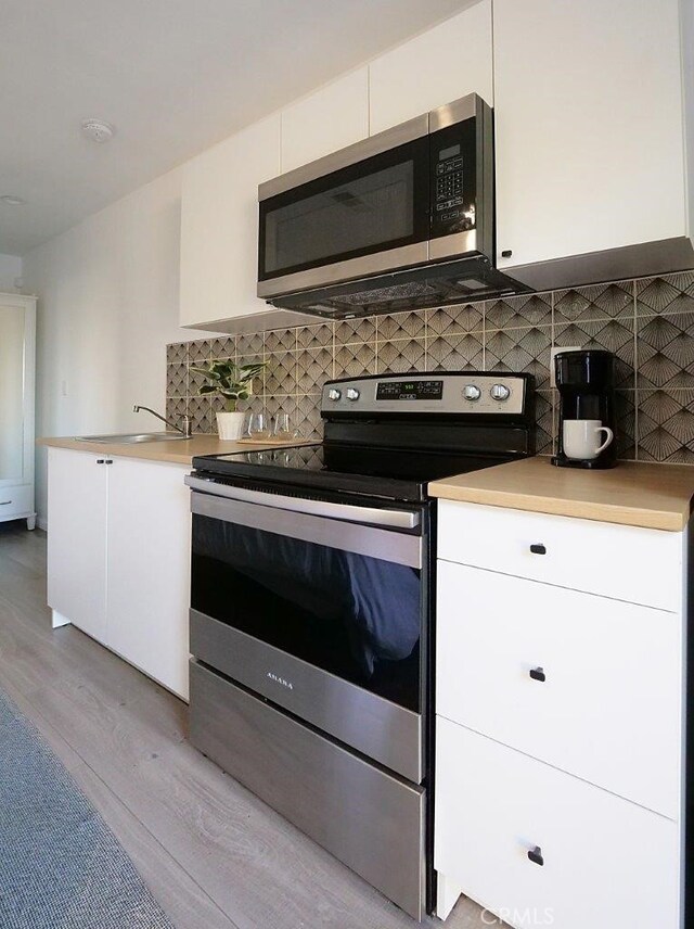 5435 W 76th St, Los Angeles, CA 90045 - kitchen featuring stainless steel appliances, light wood finished floors, white cabinetry, and light countertops