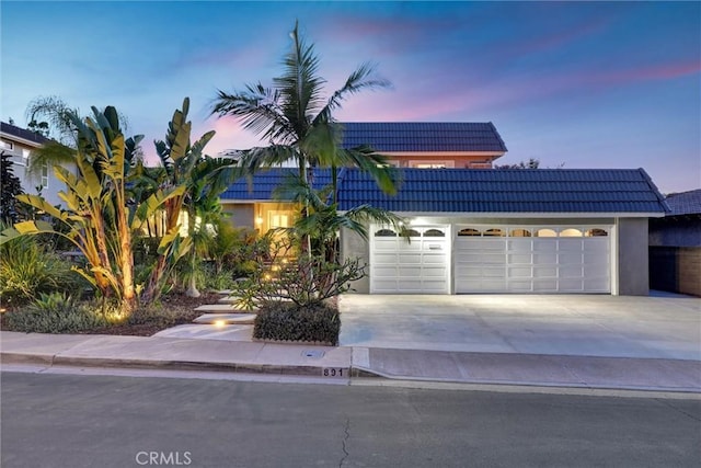 891 Palo Verde Ave, Long Beach, CA 90815 - view of front of home featuring a garage, a tile roof, driveway, and stucco siding