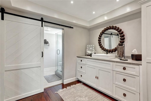 891 Palo Verde Ave, Long Beach, CA 90815 - bathroom featuring hardwood / wood-style floors, vanity, a stall shower, a tray ceiling, and recessed lighting