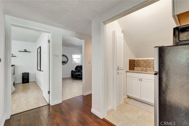 891 Palo Verde Ave, Long Beach, CA 90815 - hall featuring a sink and wood finished floors