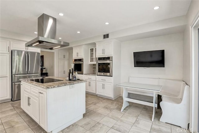 891 Palo Verde Ave, Long Beach, CA 90815 - kitchen featuring island range hood, stainless steel appliances, white cabinetry, light stone counters, and recessed lighting