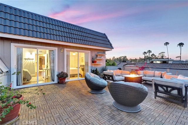 891 Palo Verde Ave, Long Beach, CA 90815 - patio terrace at dusk featuring an outdoor living space with a fire pit and a patio area