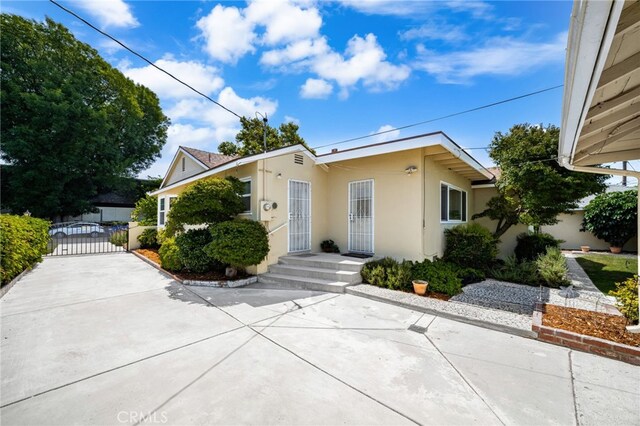 209 S Homerest Ave, West Covina, CA 91791 - view of front of property featuring stucco siding and a gate