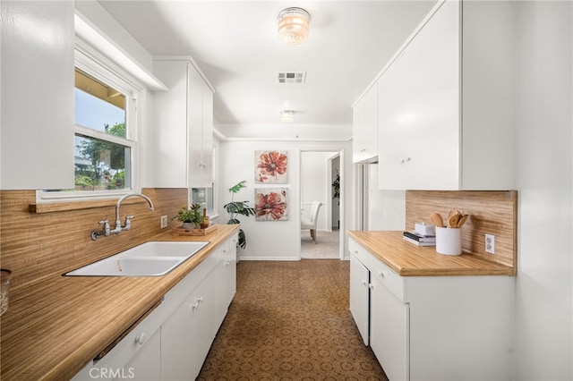 209 S Homerest Ave, West Covina, CA 91791 - kitchen with backsplash, white cabinets, and dark floors