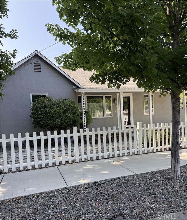 315 W 6th Ave, Chico, CA 95926 - view of front of house with a fenced front yard, stucco siding, and roof with shingles