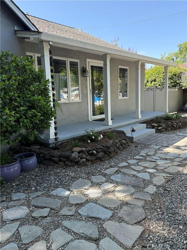 315 W 6th Ave, Chico, CA 95926 - doorway to property featuring a porch, stucco siding, and roof with shingles