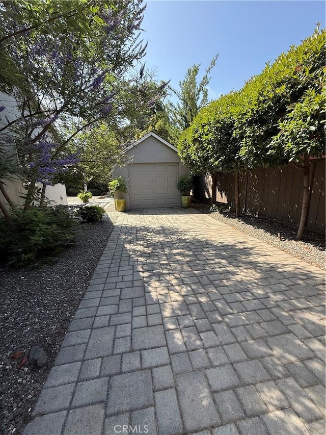 315 W 6th Ave, Chico, CA 95926 - view of patio with a garage, an outdoor structure, and decorative driveway
