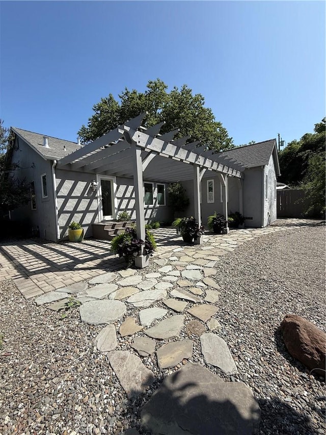 315 W 6th Ave, Chico, CA 95926 - back of property featuring a pergola, a patio area, a shingled roof, and stucco siding