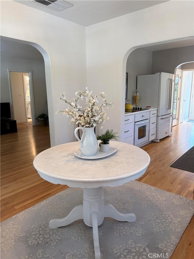 315 W 6th Ave, Chico, CA 95926 - dining area featuring arched walkways and light wood finished floors