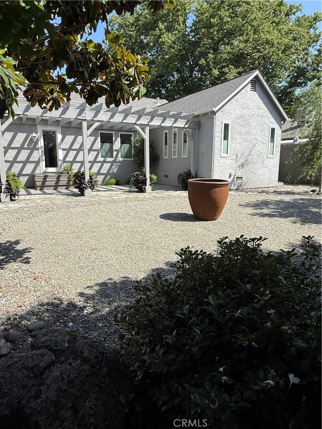 315 W 6th Ave, Chico, CA 95926 - rear view of property featuring stucco siding, a pergola, and a shingled roof