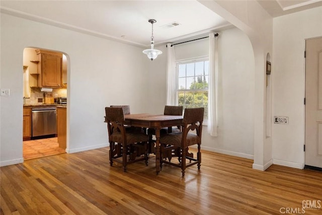 700 Hillcrest Dr, Bakersfield, CA 93305 - dining space with arched walkways and light wood finished floors