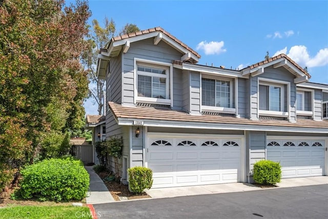 13562 Mahogany Pl, Tustin, CA 92782 - view of property with a tiled roof and an attached garage