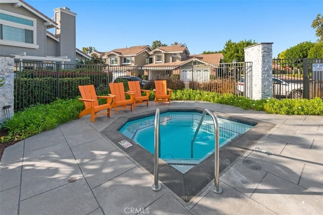 13562 Mahogany Pl, Tustin, CA 92782 - view of swimming pool with a community hot tub, a residential view, a patio area, and a swimming pool