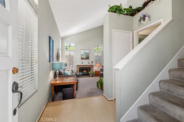13562 Mahogany Pl, Tustin, CA 92782 - entrance foyer with wood finished floors, stairway, lofted ceiling, and a brick fireplace