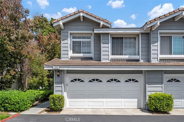 13562 Mahogany Pl, Tustin, CA 92782 - multi unit property with a tile roof, a garage, and driveway