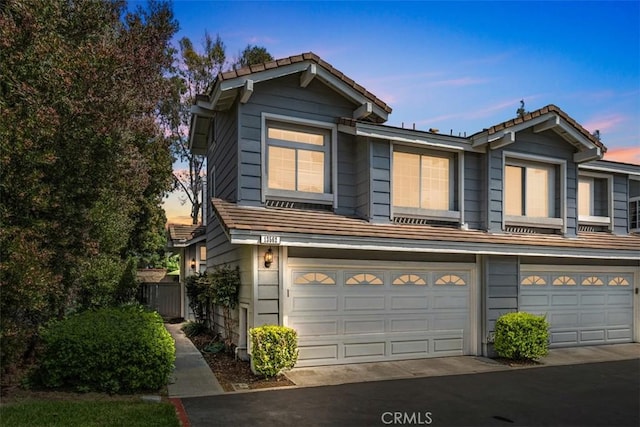 13562 Mahogany Pl, Tustin, CA 92782 - view of property featuring a tile roof and a garage