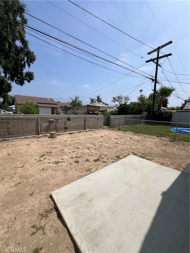 246 E 27th St, San Bernardino, CA 92404 - fenced backyard featuring a trampoline and a patio