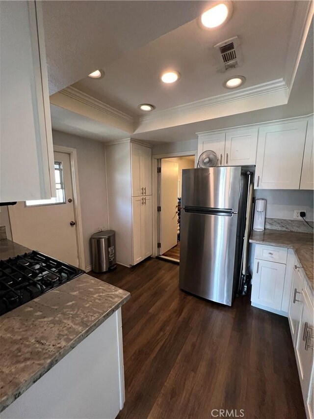 246 E 27th St, San Bernardino, CA 92404 - kitchen featuring freestanding refrigerator, a tray ceiling, crown molding, white cabinetry, and dark wood finished floors