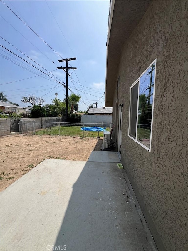 246 E 27th St, San Bernardino, CA 92404 - fenced backyard featuring a patio area and a trampoline