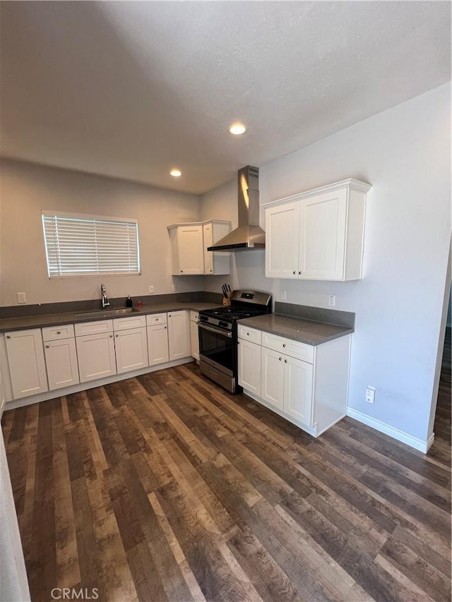 246 E 27th St, San Bernardino, CA 92404 - kitchen with gas stove, wall chimney exhaust hood, dark countertops, dark wood-type flooring, and recessed lighting